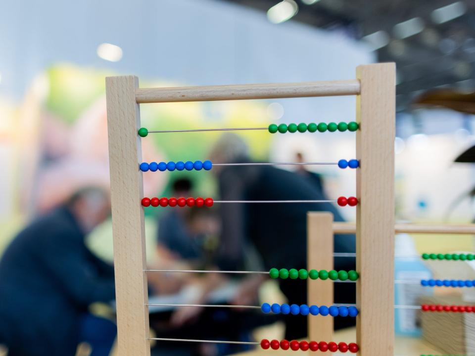 Colorful beads on a teaching toy used in Montessori education