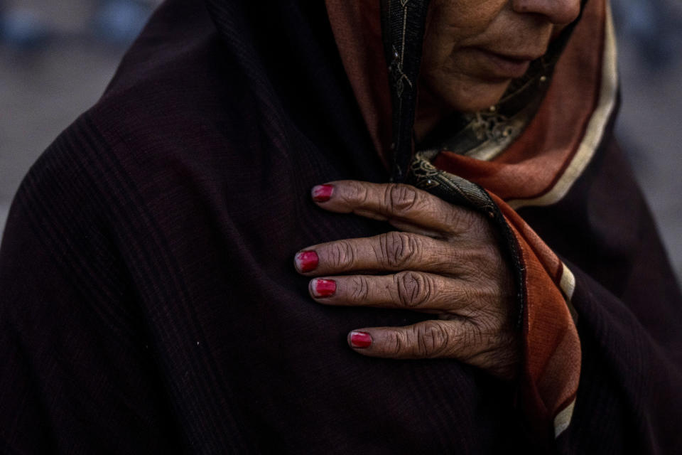 An Indian pilgrim holds her scarf as she embarks on a visit to the sacred Pashupatinath temple in Kathmandu, Nepal, Jan. 12, 2024. The centuries-old temple is one of the most important pilgrimage sites in Asia for Hindus. Nepal and India are the world’s two Hindu-majority nations and share a strong religious affinity. Every year, millions of Nepalese and Indians visit Hindu shrines in both countries to pray for success and the well-being of their loved ones. (AP Photo/Niranjan Shrestha)