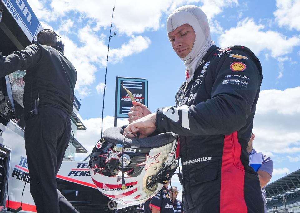 Team Penske driver Josef Newgarden (2) puts on his helmet Friday, May 10, 2024, during practice for the Sonsio Grand Prix at Indianapolis Motor Speedway.