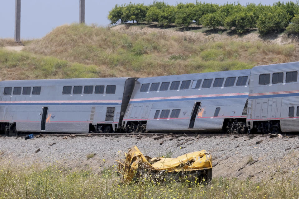 A destroyed truck lies near a derailed Amtrak train in Moorpark, Calif., on Wednesday, June 28, 2023. Authorities say the Amtrak passenger train carrying 190 passengers derailed after striking a vehicle on tracks in Southern California. Only minor injuries were reported. (Dean Musgrove/The Orange County Register via AP)