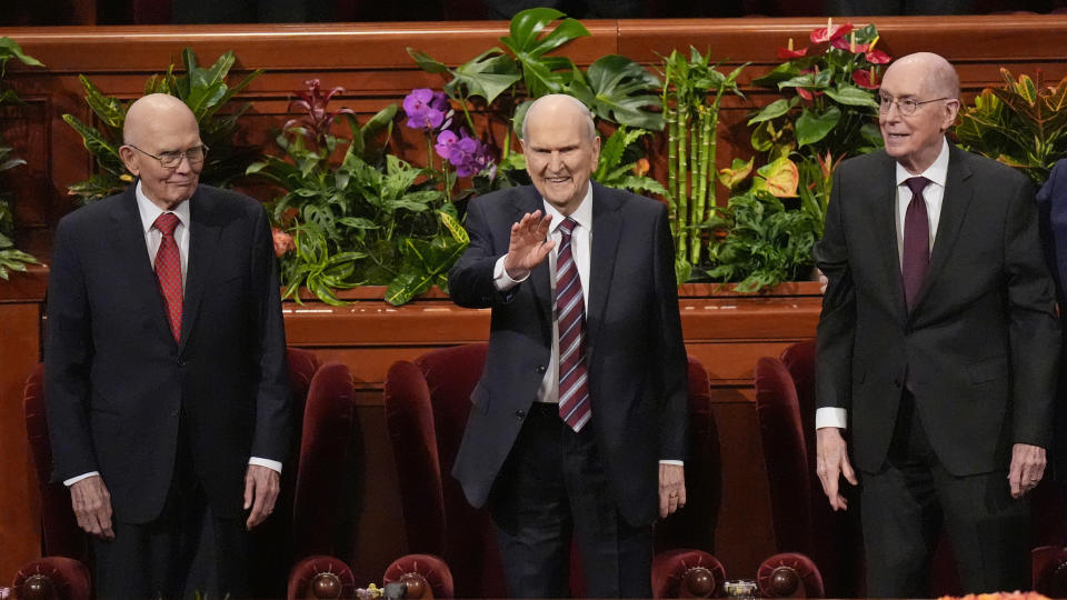 President Russell M. Nelson, center, waves as his counselors Dallin H. Oaks, left, and Henry B. Eyring, right, look on during The Church of Jesus Christ of Latter-day Saints conference, Sunday, April 7, 2024, in Salt Lake City. (AP Photo/Rick Bowmer)