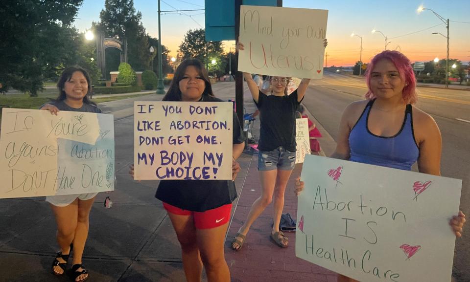 Protesters on Garrison Avenue in Fort Smith from left to right are Kiera Taylor of Heavener, Oklahoma, MeKailan James of Poteau, Oklahoma, Jessica Martin, of Poteau, and Lea Taylor of Heavener, wave signs supporting abortion rights on Garrison Avenue.