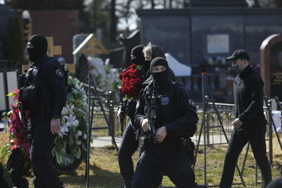 Armed Russian policemen guard an area during a funeral ceremony of slain Russian military blogger Vladlen Tatarsky, at the Troyekurovskoye cemetery in Moscow, Russia, Saturday, April 8, 2023. Tatarsky, known by his pen name of Maxim Fomin, was killed on Sunday, April 2, as he led a discussion at a riverside cafe in the historic heart of St. Petersburg, Russia's second-largest city. (Anton Velikzhanin, M24/Moscow News Agency via AP)