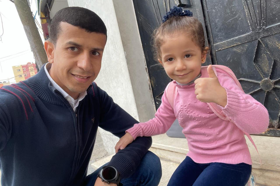 In this photo provided by the family, Ramzy Abu al-Qumssan sits with his daughter, Nur, outside their home in Gaza's Jabaliya Refugee camp on Oct. 22, 2022. His wife, Asmaa, and Nur, 5, were killed in an Israeli airstrike on their home on Nov. 16, 2023, along with 15 other relatives. (Courtesy Ramzy Abu al-Qumssan via AP)
