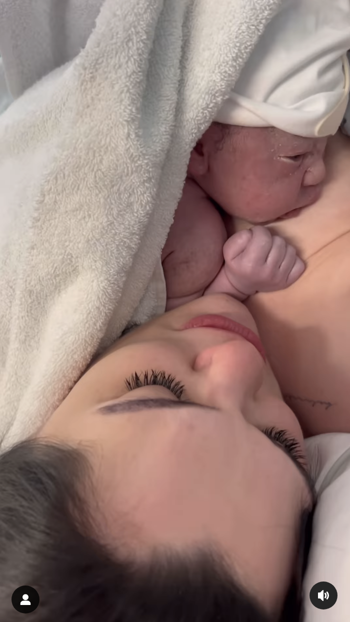 Close-up of Jessie lying down with her baby resting on her chest