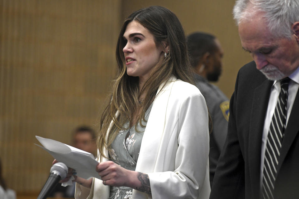 Shannon Spies, girlfriend of Nicholas Eisele, reads a victim's impact statement during the sentencing hearing for Peter Manfredonia in Milford Superior Court, in Milford, Conn., Wednesday, April 19, 2023. Manfredonia was sentenced to 55 years in prison Wednesday for the 2020 murder of Eisele, a former high school classmate, in Derby, and then kidnapping Spies. (Ned Gerard/Hearst Connecticut Media via AP, Pool)
