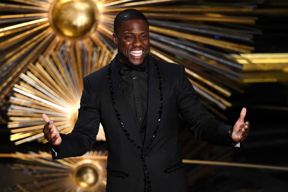 <p>Kevin Winter/Getty </p> Kevin Hart onstage at the 88th Academy Awards in 2019