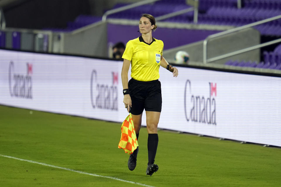 Assistant referee Kathryn Nesbitt runs the sideline as she watches play between Bermuda and Canada during the first half of a World Cup 2022 Group B qualifying soccer match, Thursday, March 25, 2021, in Orlando, Fla. Nesbitt, a 32-year-old from Philadelphia, had a breakthrough moment when she became the first woman to work as an on-field official for a World Cup qualifier in North and Central America and the Caribbean. (AP Photo/John Raoux)