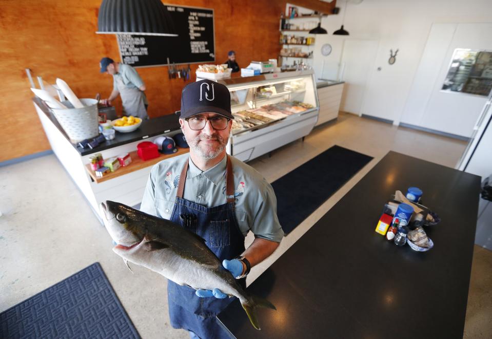 Christopher Nelson holds a hiramasa at Nelson's Meat + Fish in Phoenix, Ariz. April 10, 2018.