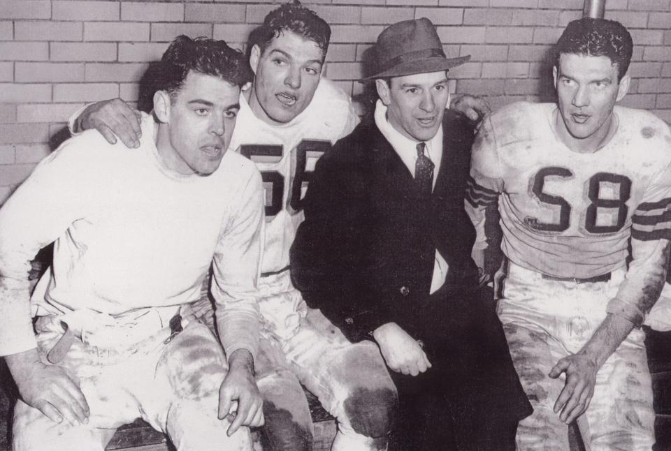 Cleveland Browns players (from left) Otto Graham, Dante Lavelli and Mac Speedie celebrate a win with their head coach, Paul Brown. All four men are members of the Pro Football Hall of Fame.