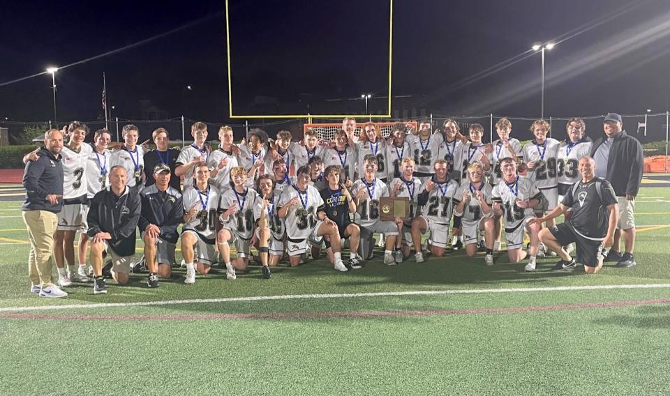 Corning's boys lacrosse team with its championship plaque after a 12-3 win over Ithaca in the Section 4 Class A final May 26, 2022 at Union-Endicott.