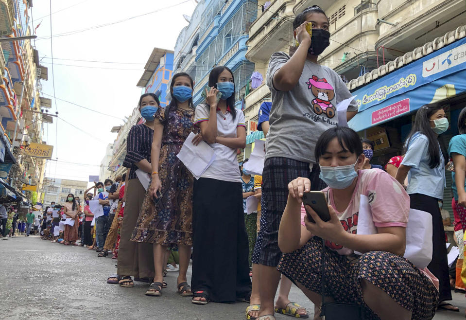 People stand in lines to get COVID-19 tests in Samut Sakhon, South of Bangkok, Thailand, Sunday, Dec. 20, 2020. Thailand reported more than 500 new coronavirus cases on Saturday, the highest daily tally in a country that had largely brought the pandemic under control. (AP Photo/Jerry Harmer)