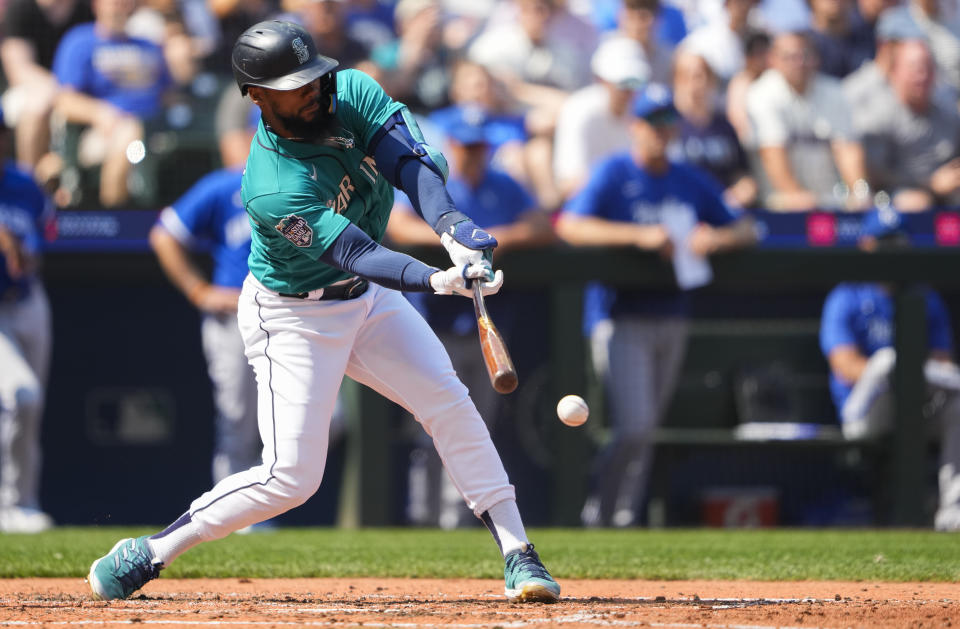 Seattle Mariners' Teoscar Hernandez grounds into a forceout of Cal Raleigh at second base, scoring J.P. Crawford against the Kansas City Royals during the fourth inning of a baseball game Saturday, Aug. 26, 2023, in Seattle. (AP Photo/Lindsey Wasson)