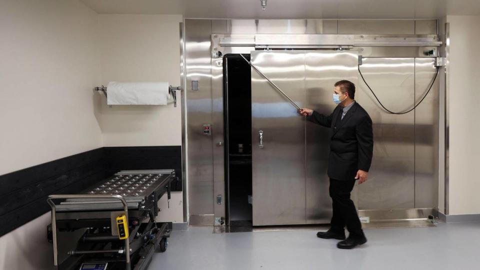 Brett E. Harding, chief deputy coroner for Ada County, slides open the morgue cooler where most bodies are kept in this 2021 file photo. Harding said he supports recommendations to overhaul Idaho’s coroner and death investigation policies.