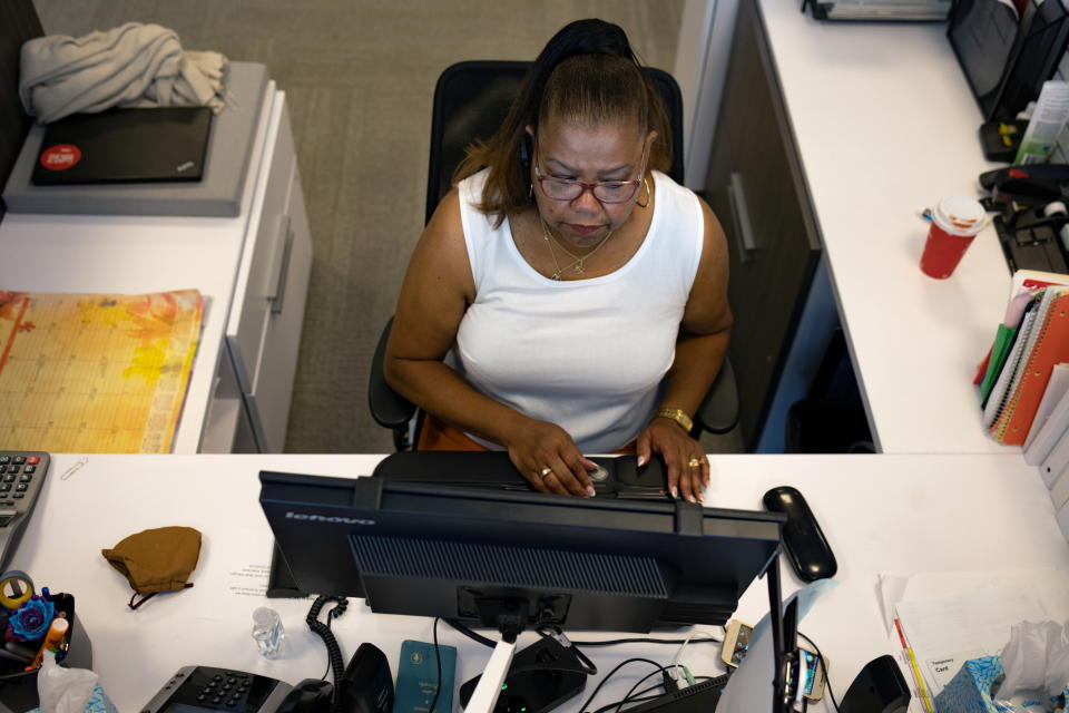 A woman works on her computer as the first phase of FMC Corporation employees return to work in the office in Philadelphia, Pennsylvania, U.S., June 14, 2021. REUTERS/Hannah Beier