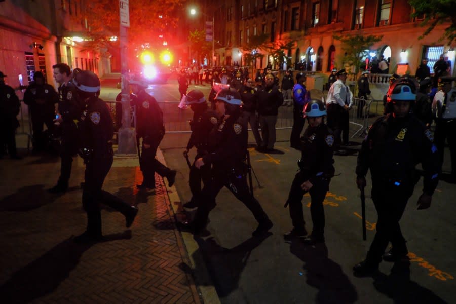 Members of the New York Police Department strategic response team move towards an entrance to Columbia University, Tuesday, April 30, 2024, in New York. After entering the campus, a contingent of police officers approached Hamilton Hall, the administration building that student protesters began occupying in the morning. (AP Photo/Julius Motal)