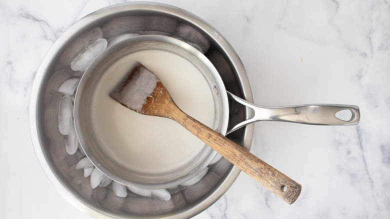 milk in saucepan over ice