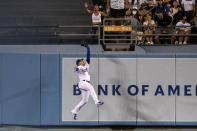 Los Angeles Dodgers center fielder Trayce Thompson catches a fly ball at the wall hit by Miami Marlins' Nick Fortes during the ninth inning of a baseball game in Los Angeles, Friday, Aug. 19, 2022. (AP Photo/Alex Gallardo)