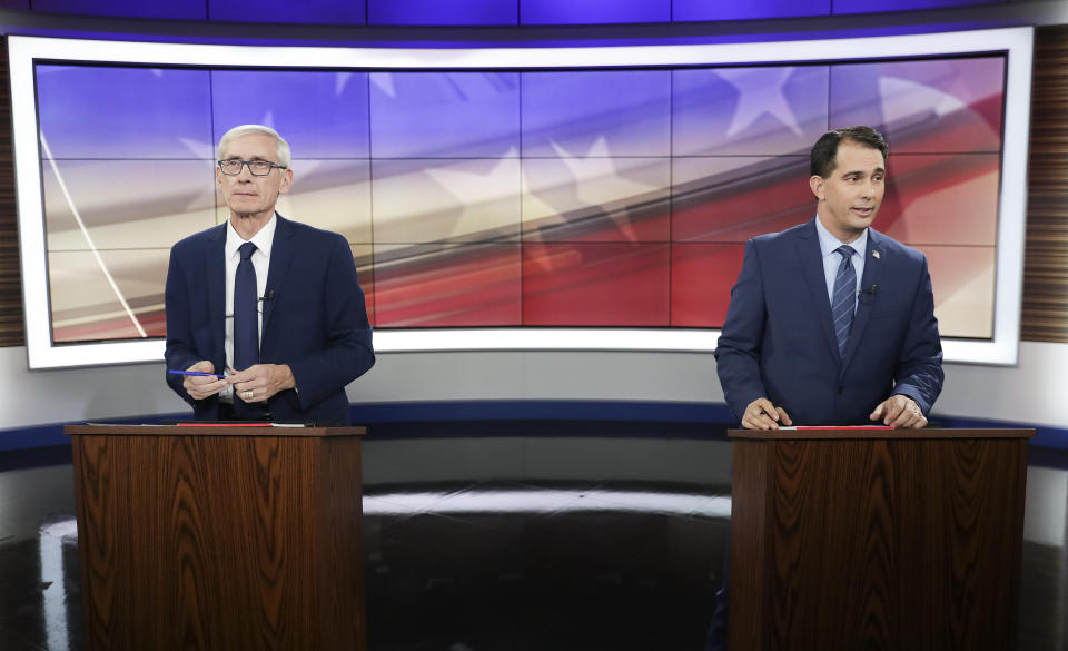 Democratic challenger Tony Evers, left, and Gov. Scott Walker, a Republican, participate in a 10-minute media event before the start of their gubernatorial debate hosted by the Wisconsin Broadcasters Association Foundation in Madison, Wis., on Oct. 19, 2018. (Photo: Steve Apps/Wisconsin State Journal via AP)