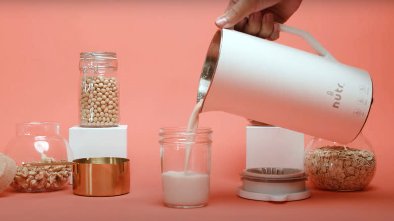  Pouring milk from nutr machine into glass