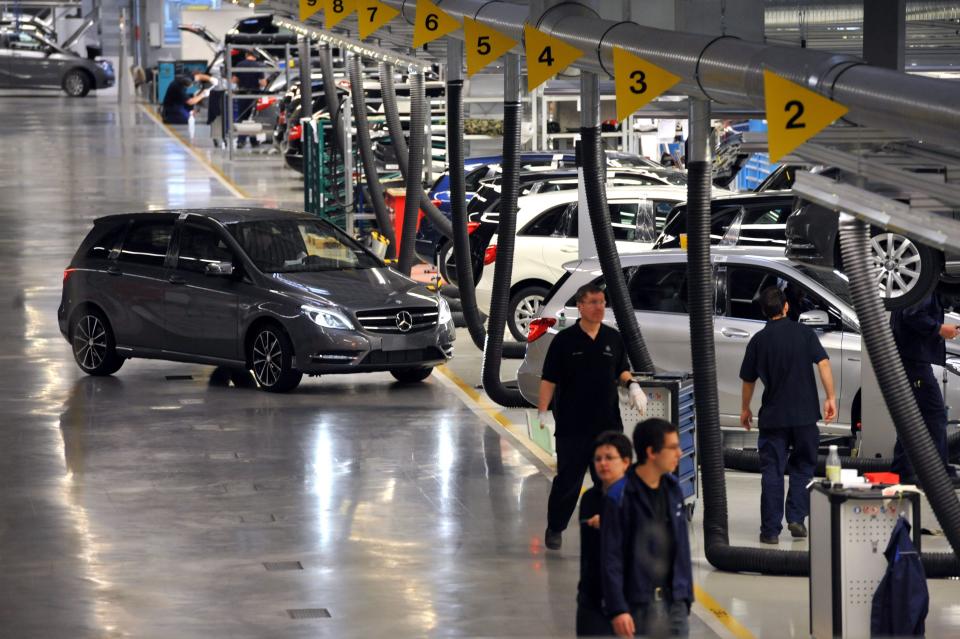 Workers and assembled cars are seen in the assembly hall in the new Mercedes Benz plant in Kecskemet, 83 kilometers southeast of Budapest, Hungary, prior to the the official inauguration ceremony of the Kecskemet Mercedes factory on Thursday, 29 March, 2012. The new Mercedes plant built on a basic territory of 441 hectares with an investment of 800 million euros has a yearly capacity of 100 thousand cars of two types of compact B-Class produced by 2,500 employees. (AP Photo/MTI, Tamas Kovacs)