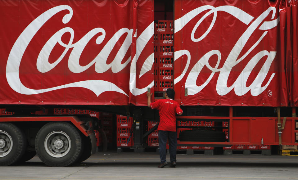 A worker checks his truck at PT Coca-Cola Amatil Indonesia's factory in Cibitung, Indonesia's West Java province, February 24, 2011. The Australian-based bottler and distributor for Coca Cola across Oceania had invested AUD$100 million ($101 million) in Indonesia over three years, doubling the company's investment in the country, Business Service Director Bruce Waterfield said during a media tour at the factory on Thursday. REUTERS/Beawiharta (INDONESIA - Tags: BUSINESS FOOD)