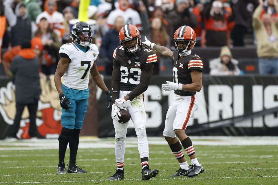 Cleveland Browns cornerback Martin Emerson Jr. (23) celebrates his interception with teammate cornerback Greg Newsome II (0) during the first half of an NFL football game against the Jacksonville Jaguars, Sunday, Dec. 10, 2023, in Cleveland. (AP Photo/Ron Schwane)