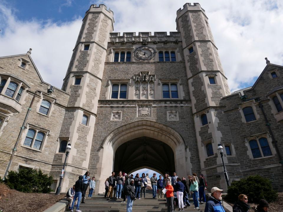 People walk through the Princeton University campus in Princeton, N.J., Thursday, April 5, 2018.
