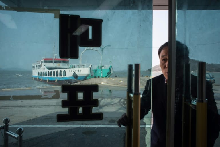 A man enters a ticketing office for ferries to nearby islands, at Paengmok harbour on South Korea's southern island of Jindo