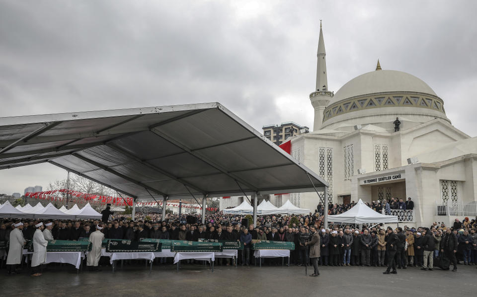 Turkey's President Recep Tayyip Erdogan and other officials join hundreds of mourners who attend the funeral prayers for nine members of Alemdar family killed in a collapsed apartment building, in Istanbul, Saturday, Feb. 9, 2019. Erdogan says there are "many lessons to learn" from the collapse of a residential building in Istanbul where at least 17 people have died. (AP Photo/Emrah Gurel)