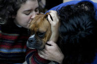 Agustina Ancales and her partner Pablo Vazquez pose for a photo with their dog Sigmoide in Lomas de Zamora, Argentina, Wednesday, Sept. 8, 2021. Ancales' mother got the dog for the couple as a gift after Vazquez was diagnosed with cancer during the COVID-19 lockdown to try to cheer them up. (AP Photo/Natacha Pisarenko)