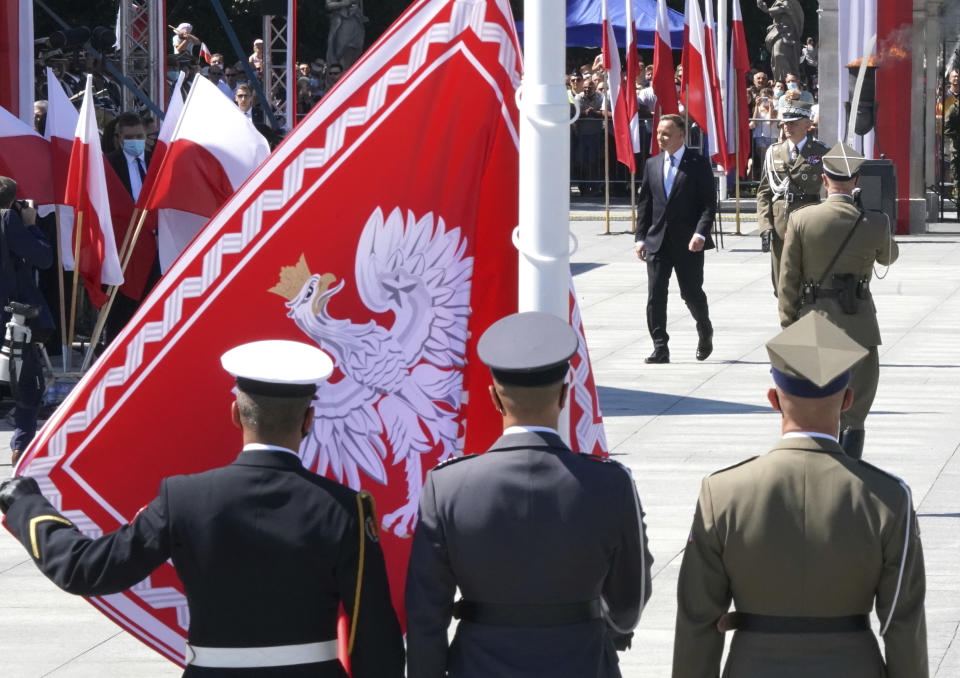 Poland's President Andrzej Duda, right, attends a ceremony commemorating the 100th anniversary of the Battle of Warsaw at the Pilsudski square in Warsaw, Poland, Saturday Aug. 15, 2020. (Janek Skarzynski/Pool via AP)