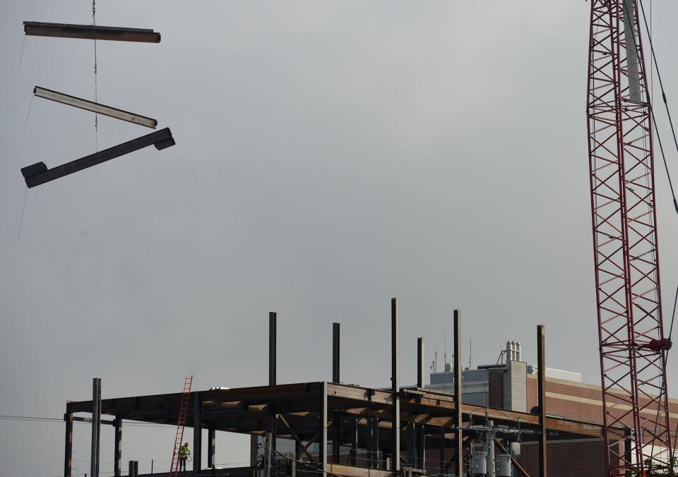 Steel beams "fly" into place with the assistance of a crane as Cape Cod Hospital's new tower is rising up next to the main building in Hyannis. The tower will house cardiac care and cancer treatments.