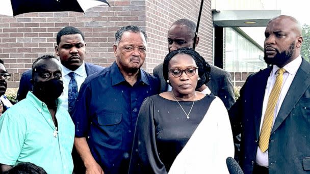 PHOTO: Wanda Cooper-Jones and Marcus Arbery, parents of Ahmaud Arbery, are flanked by Rev. Jesse Jackson and Attorney Lee Merritt while addressing the media following the sentencing of Travis McMichael in federal court in Brunswick, Ga. on Aug. 8, 2022. (Lewis M. Levine/AP)