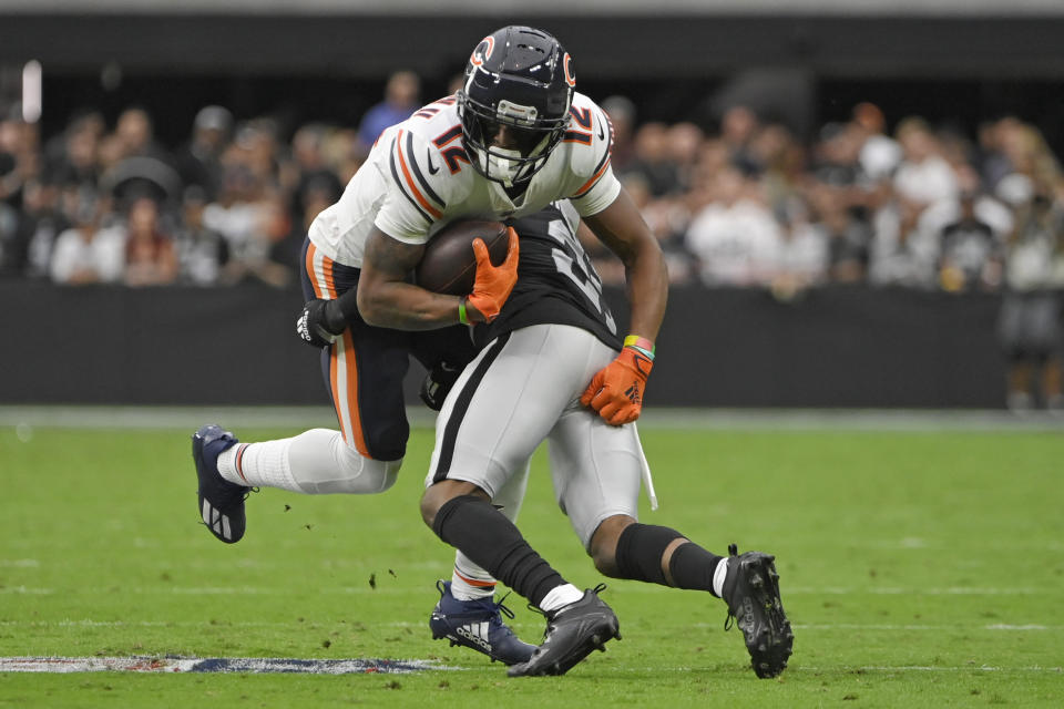 Las Vegas Raiders cornerback Amik Robertson (21) tackles Chicago Bears wide receiver Allen Robinson (12) after Robinson made a catch during the first half of an NFL football game, Sunday, Oct. 10, 2021, in Las Vegas. (AP Photo/David Becker)