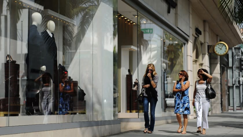 Shoppers along Beverly Hill's Rodeo Drive look into the Salvadore Ferragamo store in 2011.