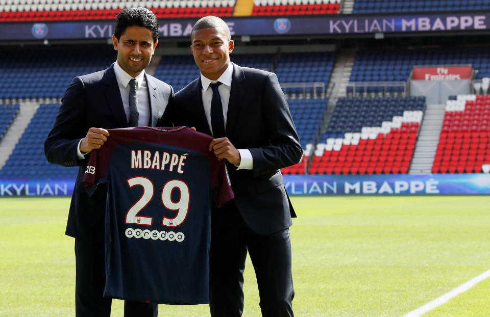 Soccer Football - Paris St Germain - Kylian Mbappe Press Conference - Paris, France - September 6, 2017. New Paris St Germain signing Kylian Mbappe and Chairman and CEO Nasser Al-Khelaifi pose with the club shirt after a press conference.    REUTERS/Gonzalo Fuentes