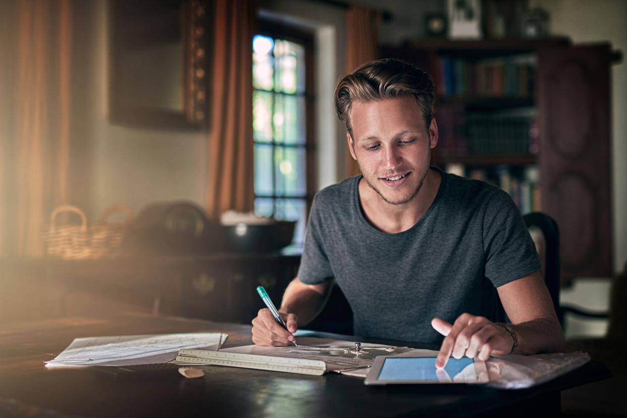 man at home at desk doing work