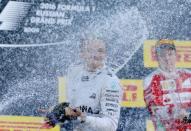 Formula One - Russian Grand Prix - Sochi, Russia - 1/5/16 - Winner Mercedes F1 driver Nico Rosberg of Germany and third placed Ferrari driver Kimi Raikkonen of Finland spray champagne after the Russian Grand Prix. REUTERS/Maxim Shemetov