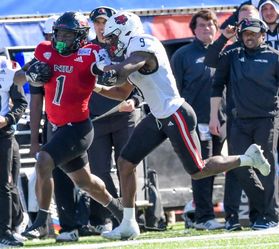 Arkansas State Red Wolves safety Trevian Thomas (9) pushes Northern Illinois Huskies running back Antario Brown (1) out of bounds after a big gain in first half action in the Camellia Bowl at Cramton Bowl in Montgomery, Ala., on Saturday December 23, 2023.