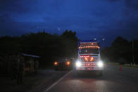 A truck decorated with crosses that light up when the driver brakes, slows down as it passes through a checkpoint, manned by soldiers from the National Guard along with immigration officers and federal police, in Comitan, Chiapas State, Mexico, Saturday, June 15, 2019. Under pressure from the U.S. to slow the flow of migrants north, Mexico plans to deploy thousands of National Guard troops by Tuesday to its southern border region.(AP Photo/Rebecca Blackwell)