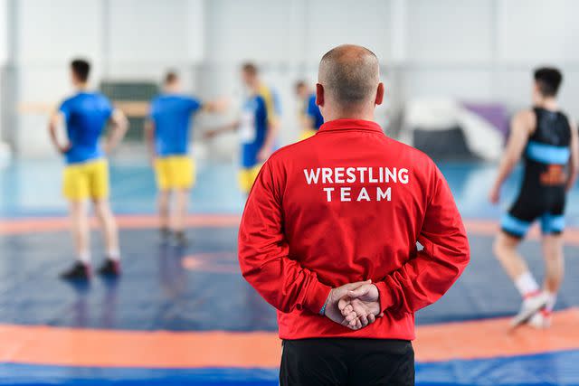 <p>getty</p> Stock image of a wrestling coach and team