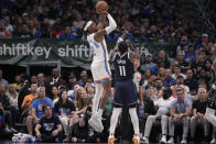 Oklahoma City Thunder guard Shai Gilgeous-Alexander (2) shoots over Dallas Mavericks guard Kyrie Irving (11) during the first half in Game 3 of an NBA basketball second-round playoff series, Saturday, May 11, 2024, in Dallas. (AP Photo/Tony Gutierrez)