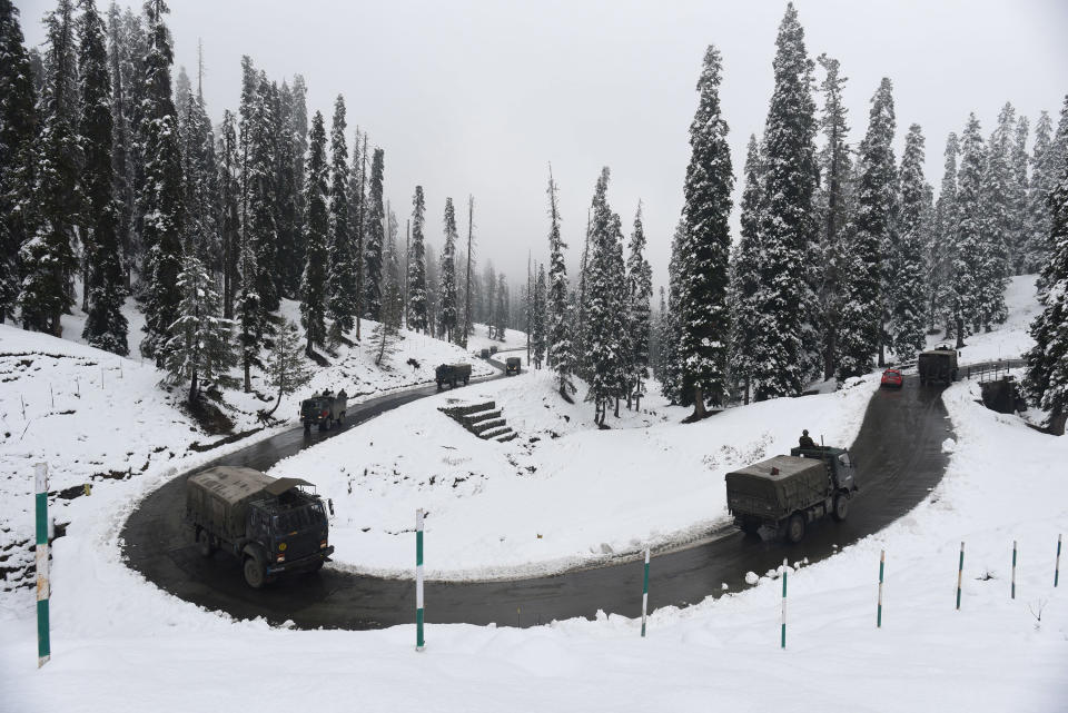 SRINAGAR, INDIA - NOVEMBER 16: Army vehicles make their way past a snow lined bend on Gulmarg road after the seasons first snowfall in the region on November 16, 2020 in Srinagar, India. (Photo by Waseem Andrabi/Hindustan Times via Getty Images)