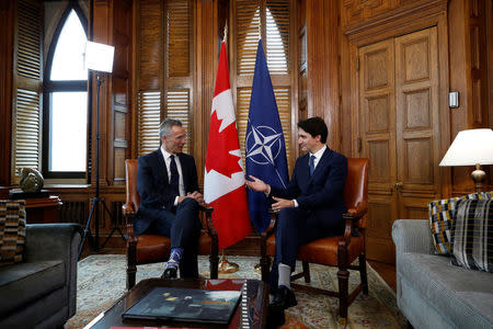 Canada's Prime Minister Justin Trudeau speaks with NATO Secretary General Jens Stoltenberg during a meeting in Trudeau's office on Parliament Hill in Ottawa, Ontario, Canada, April 4, 2018. REUTERS/Chris Wattie