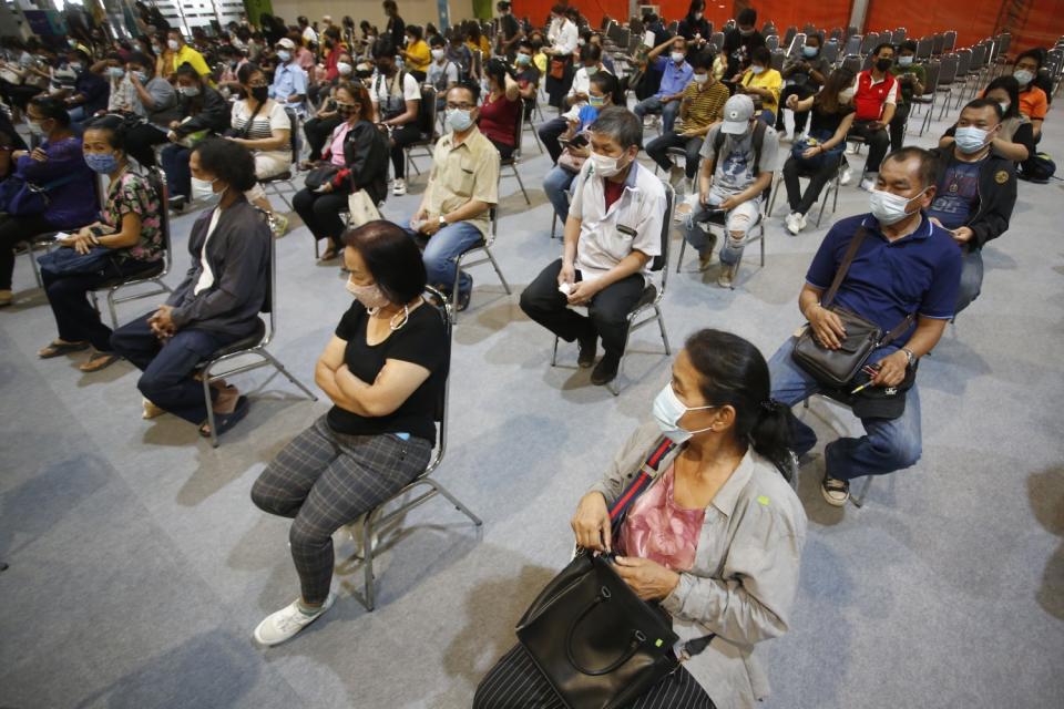 People are seated at a vaccination clinic