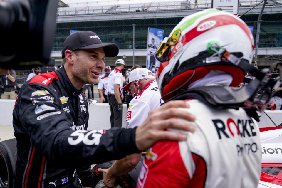 Will Power, left, of Australia, celebrates with Simona De Silvestro, of Switzerland, after they made the field during the last-row qualifications for the Indianapolis 500 auto race at Indianapolis Motor Speedway in Indianapolis, Sunday, May 23, 2021. (AP Photo/Michael Conroy)