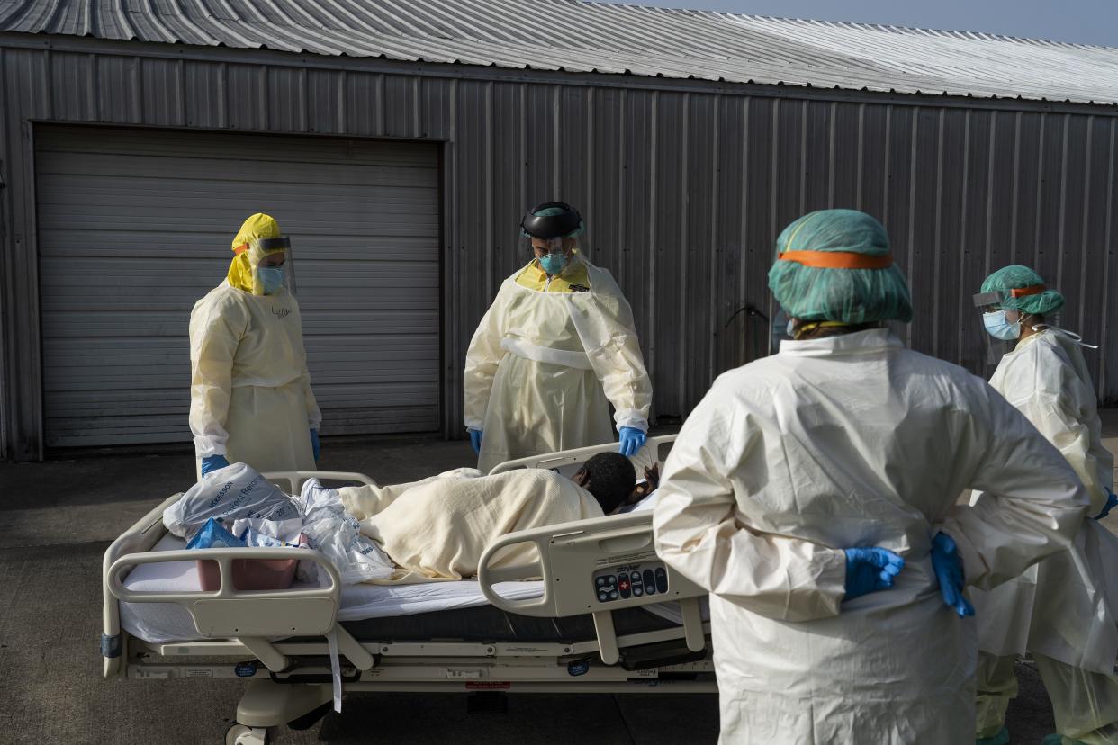 A COVID-19 intensive care patient asks to stay in the sun for a moment as members of the medical staff transfer the patient to another room at the United Memorial Medical Center on July 2, 2020 in Houston, Texas.