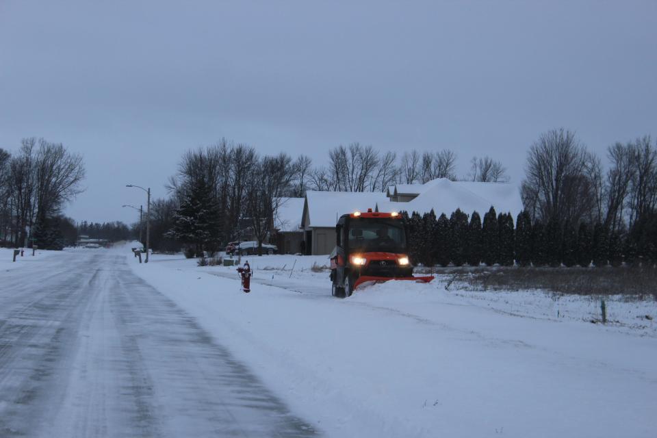 Crews clear sidewalks and roads Wednesday morning in Pulaski after the area received 2-3 inches of snow.