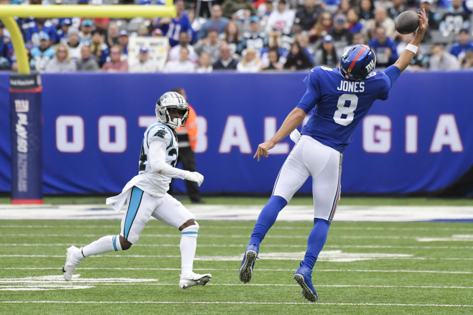 New York Giants quarterback Daniel Jones (8) catches a pass in front of Carolina Panthers' Sean Chandler (34) during the second half of an NFL football game, Sunday, Oct. 24, 2021, in East Rutherford, N.J. (AP Photo/Bill Kostroun)